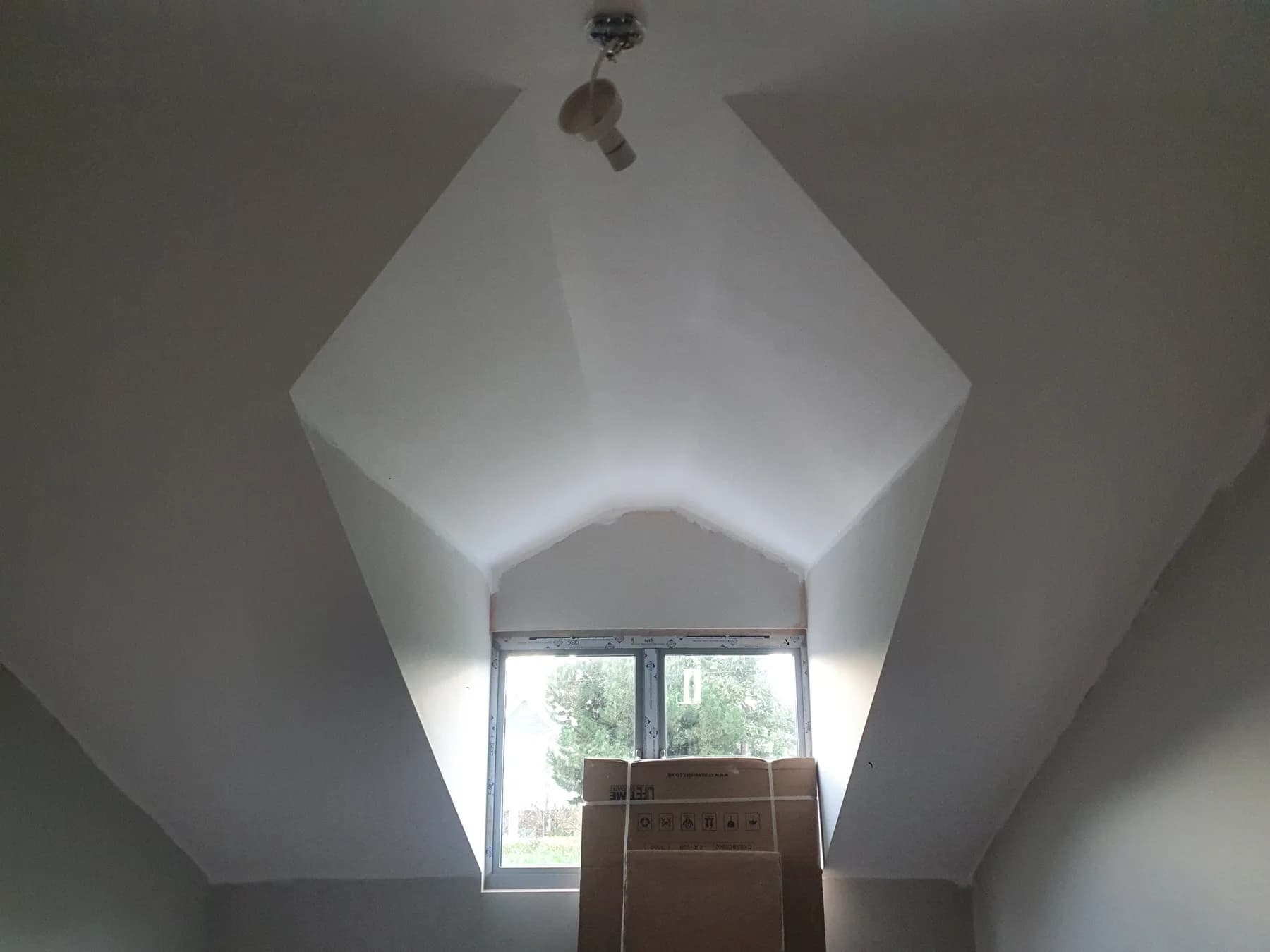 Bay window reception room after full re-plaster — smooth skim finish throughout